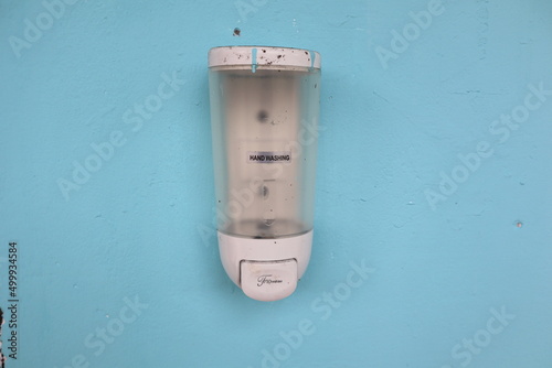 liquid soap container attached to the wall with selective focus