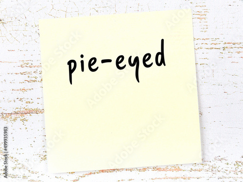 Yellow sheet of paper with word pie-eyed. Reminder concept photo