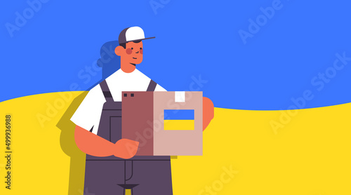 deliveryman holding help box with Ukraininan flag humanitarian aid material assistance governmental help