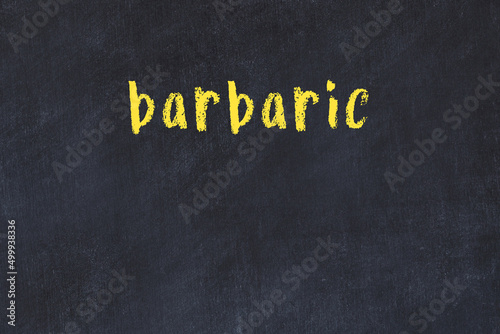 Photography College chalk desk with the word barbaric written on in