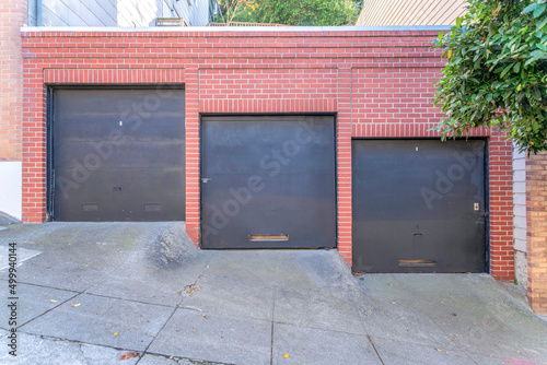 Garage exterior with three black canopy doors at San Francisco  California