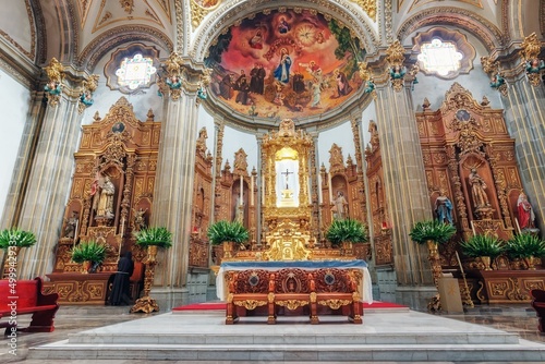 Inside a Catholic church in Mexico City. Rich facade, frescoes, icons and gold. Church space, medieval traditions