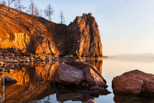 Baikal Lake on May evening. Beautiful rocks of Olkhon Island near the village of Khuzhir are illuminated by the warm light of the setting sun. Natural background. Spring travel and outdoor recreation