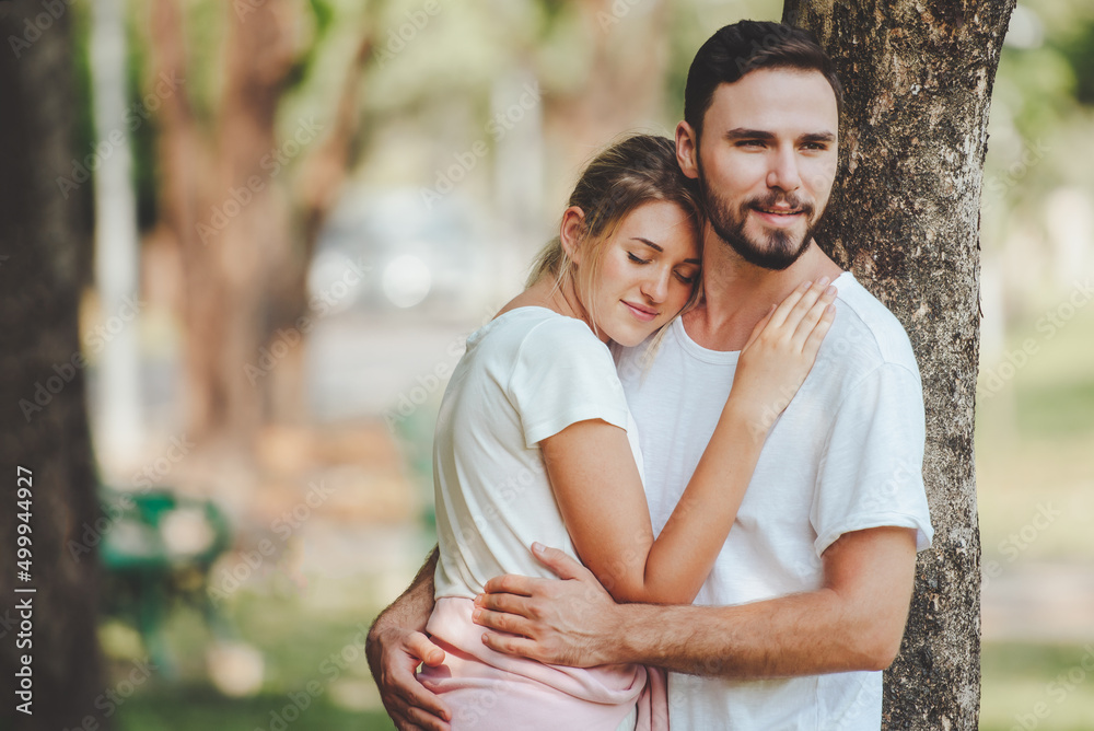 Young couple lover dating and hugging in love at spring garden park, copy space, Romantic love concept.