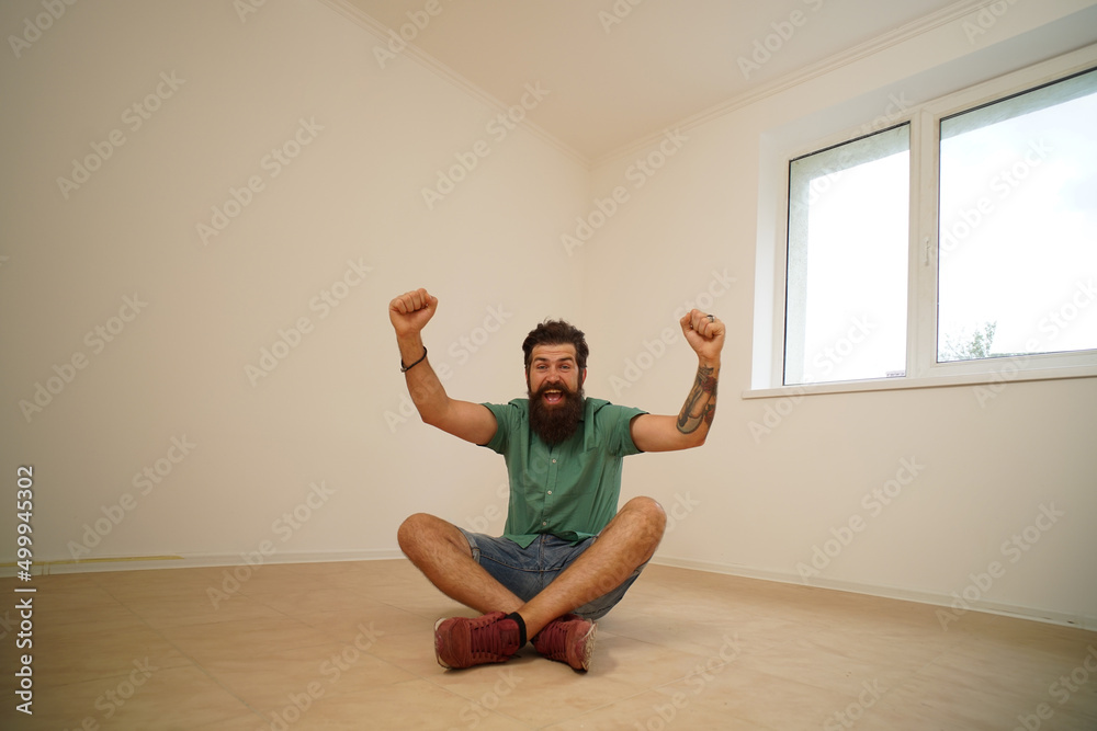 Excited man moving to new home. Moving to a empty apartment. Excited man moving to new home. Moving to a empty apartment.