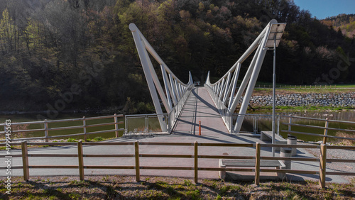 Modern bridge for bicycles over Savinja river in the Celje region on the bike path between Lasko and Celje. Modern connection between two cities photo