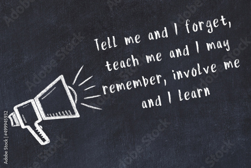 Canvas Print Chalk loudspeaker and wise quote on black desk