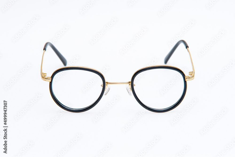 Round shape sunglasses gold and black frames on white background Round shape sunglasses gold and black frames on white background