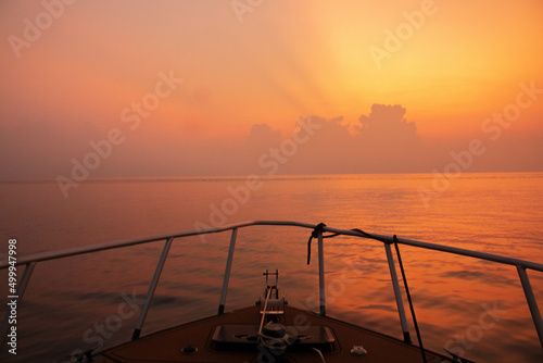 speed boat heading to the somewhere else in the sunset
