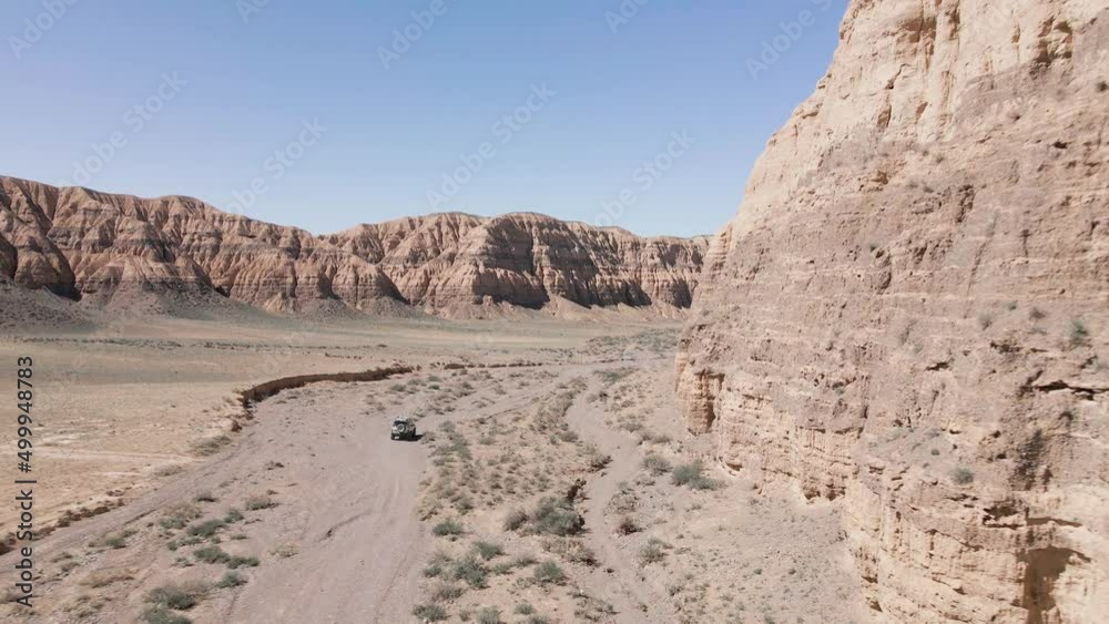 Drone shot offroad car riding in Canyon desert mountains Drone shot offroad car riding in Canyon desert mountains