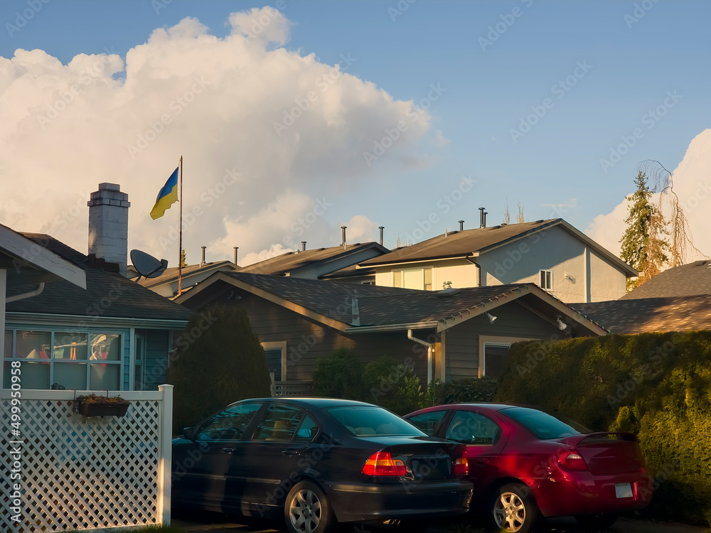 white clouds over the roofs of private houses white clouds over the roofs of private houses