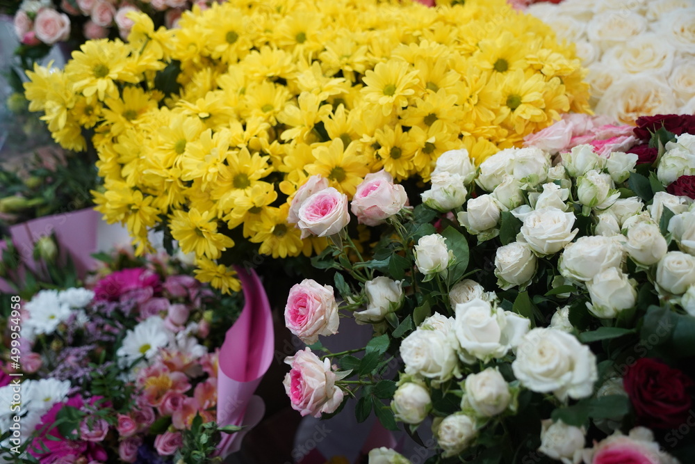 Bright bouquets of flowers with decorative paper on sale.