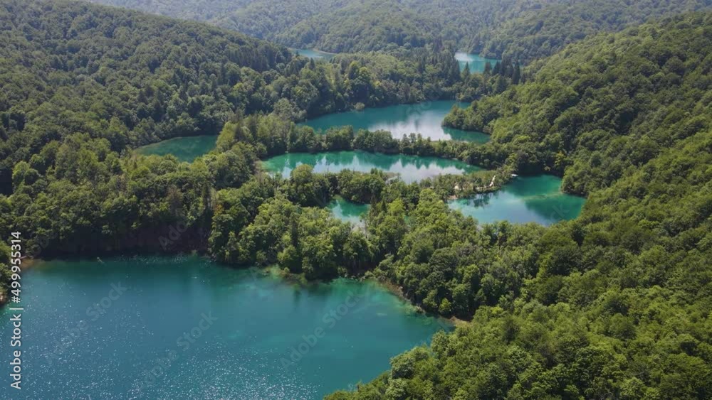 Incredible view of the beautiful Plitvice Lakes National Park with many green plants and beautiful lakes and waterfalls drone flight Incredible view of the beautiful Plitvice Lakes National Park with many green plants and beautiful lakes and waterfalls drone flight