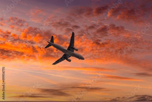 Aircraft flyingon a sunset background