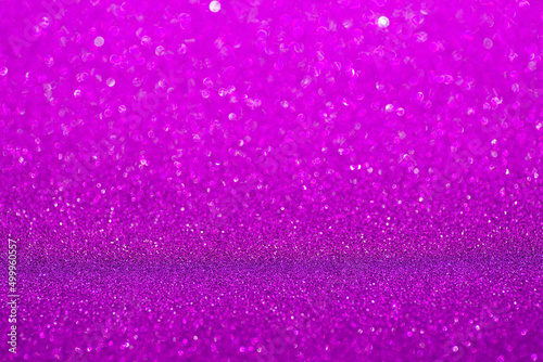 Violet glitter surface. Purple shimmer background in soft focus. Sparkling wrapping shiny paper. Texture for Christmas or Valentine holiday wallpaper for decoration
