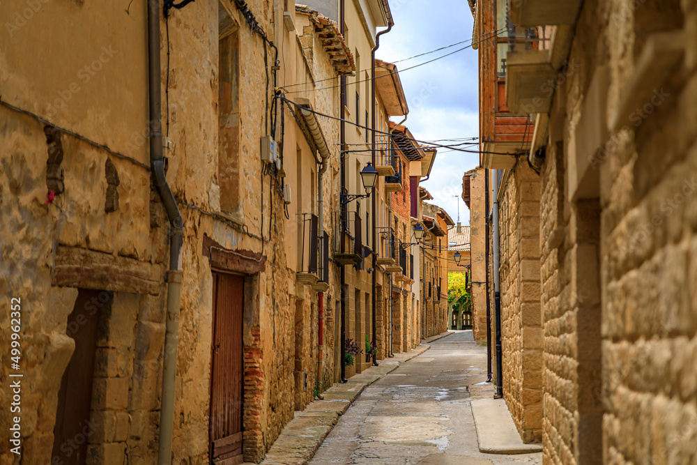 Rustic medieval stone houses in a narrow street of the old town of Olite, Spain famous for a magnificent Royal Palace castle