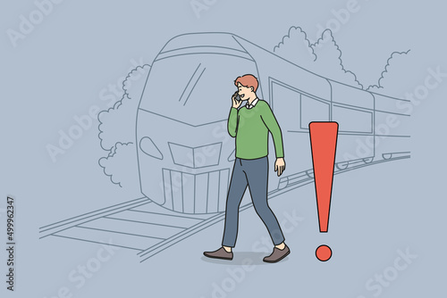 Young man talking on phone crossing tracks while train is approaching. Careless guy speak on cellphone ignore railroad safety rules and warnings. Keep back from platform edge. Vector.
