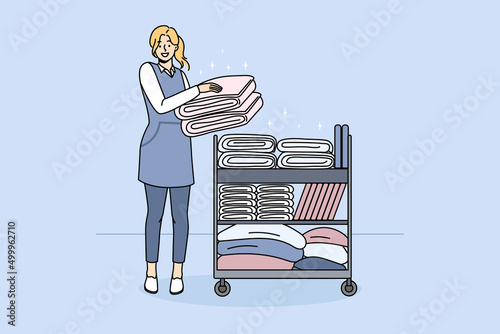 Smiling woman housekeeper with trolley with clean towels work in hotel or hostel. Happy female maid provide good quality housekeeping or laundry service. Dry cleaning. Vector illustration. 