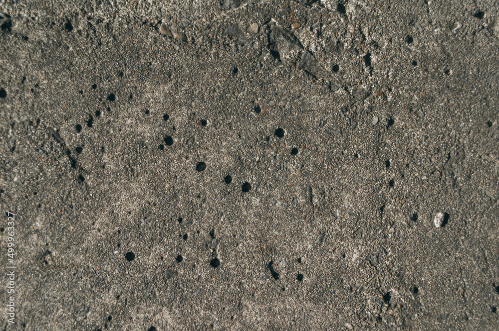 Close-up of the old concrete pavement. Dirty concrete floor. The texture of old concrete. Close-up of the old concrete pavement. Dirty concrete floor. The texture of old concrete.