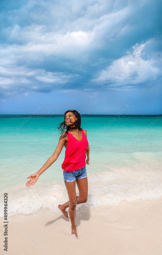 Beautiful young Afro American woman by tropical ocean Beautiful young Afro American woman by tropical ocean