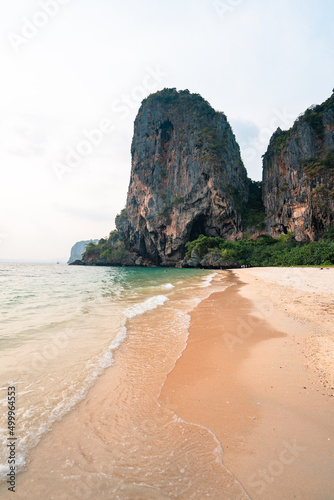 sea, beach and rocky mountains in tropical evening