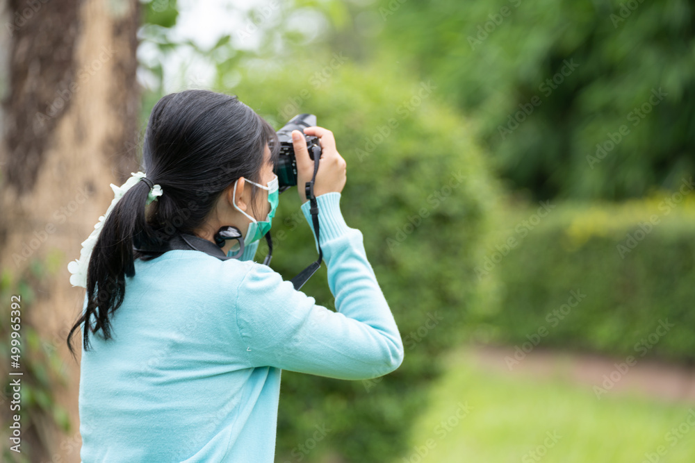 Woman is a professional photographer with camera, outdoor and sunlight, Portrait, copy space.Beautiful woman taking picture outdoors Woman is a professional photographer with camera, outdoor and sunlight, Portrait, copy space.Beautiful woman taking picture outdoors