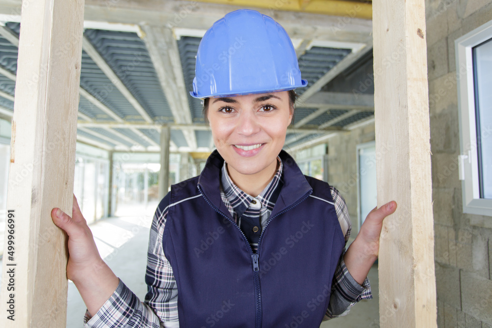 happy female builder indoors at building site happy female builder indoors at building site