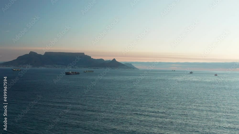 Cargo Vessels Sailing On The Coast Of South Africa With Cape Town In The Distance. - aerial Cargo Vessels Sailing On The Coast Of South Africa With Cape Town In The Distance. - aerial