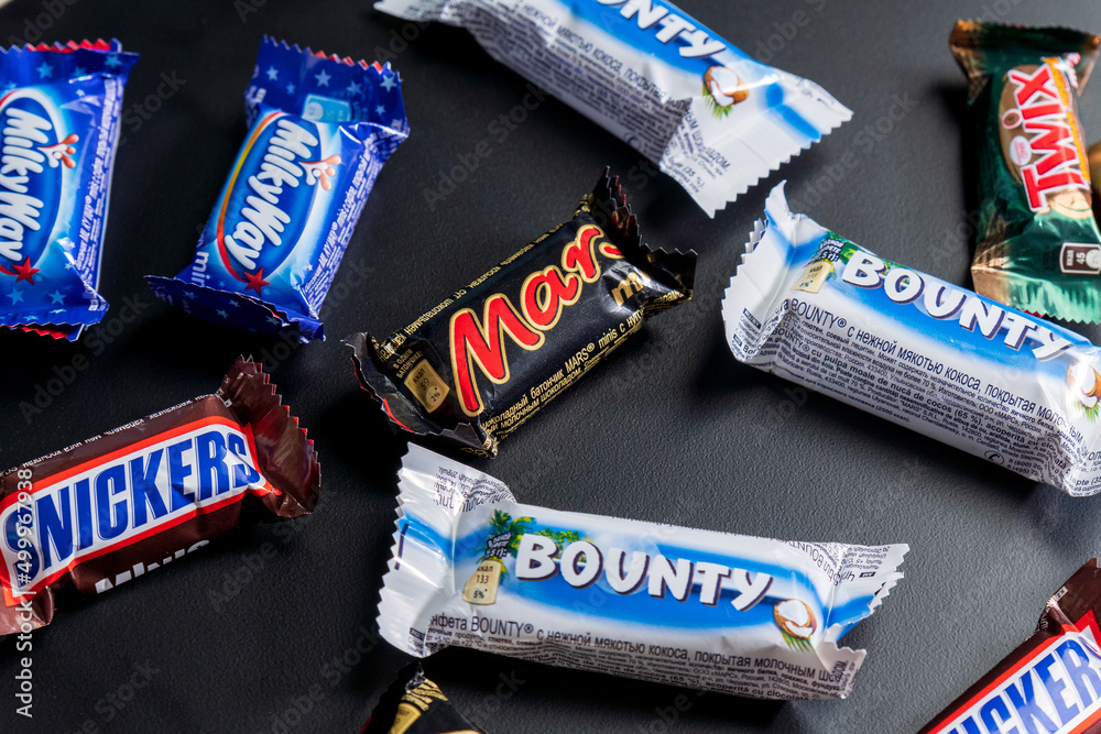 Tyumen, Russia-January 23, 2022: Stock minis Milky Way bars. Snickers, | bounty lay Twix, Photo Mars, and Stock Adobe Flat candy