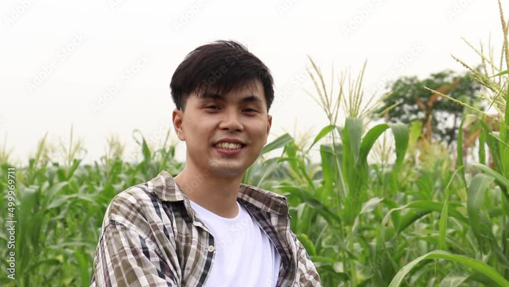 Portrait of young man with crossing hands in the casual shirt in the farm Portrait of young man with crossing hands in the casual shirt in the farm