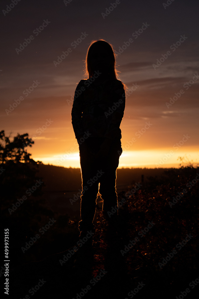 Silhouette of a little girl in front of sunset Stock Photo | Adobe Stock
