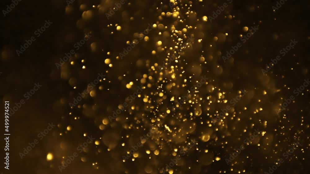 Abstract background with golden glittering particles in motion