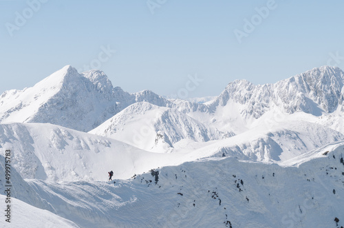 Man Hiking in winter in beautiful mountain landscape 