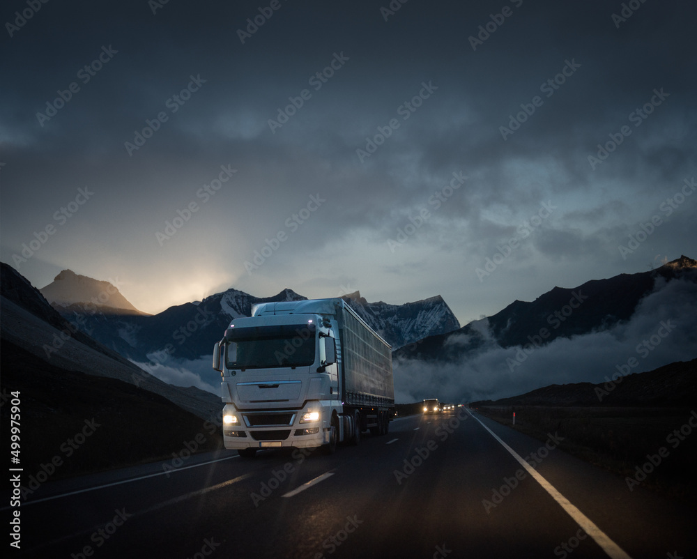 Obraz premium Truck delivering goods in a beautiful and dramatic scenery at sunset