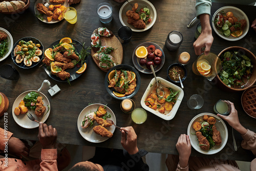 High angle view of group of people sitting at dining table and having holiday dinner