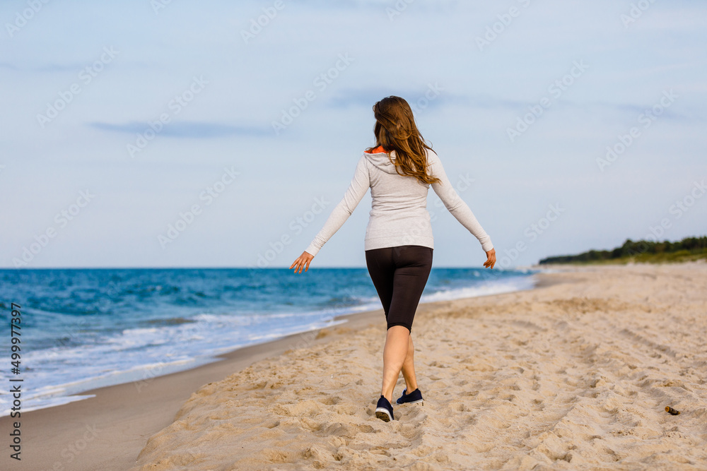 Young woman walking on beach
