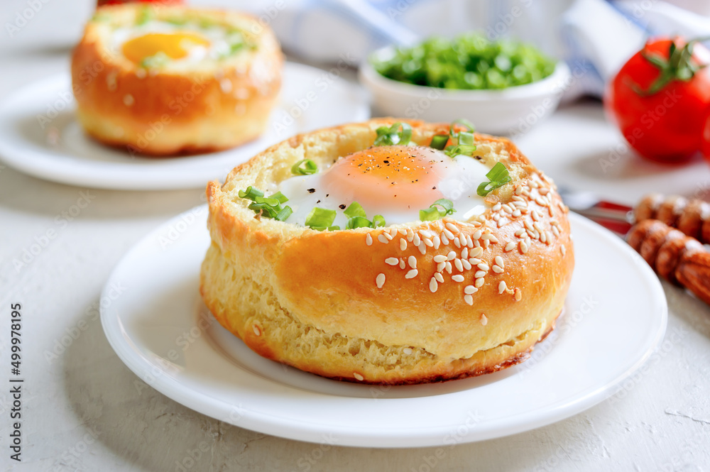 Egg baked in a soft bun with ham. Delicious and quick breakfast. Egg baked in a soft bun with ham. Delicious and quick breakfast.