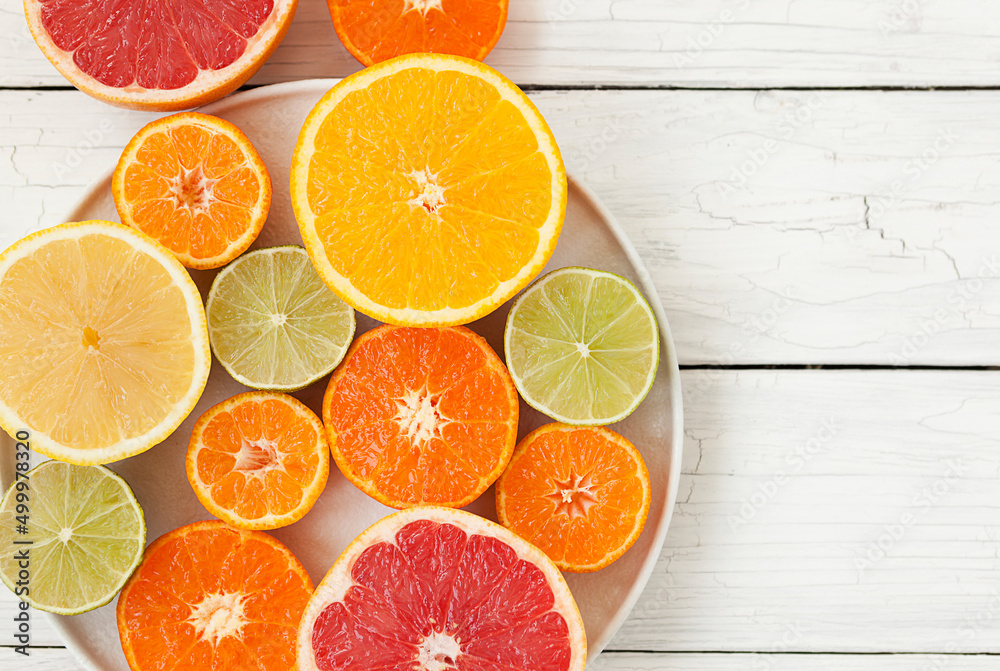 cut colored citrus fruits on a white board table, orange, grapefruit, tangerine
cut colored citrus fruits on a white board table, orange, grapefruit, tangerine