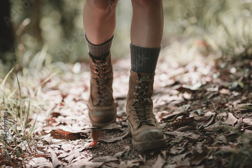 Woman hiker hiking on forest trail