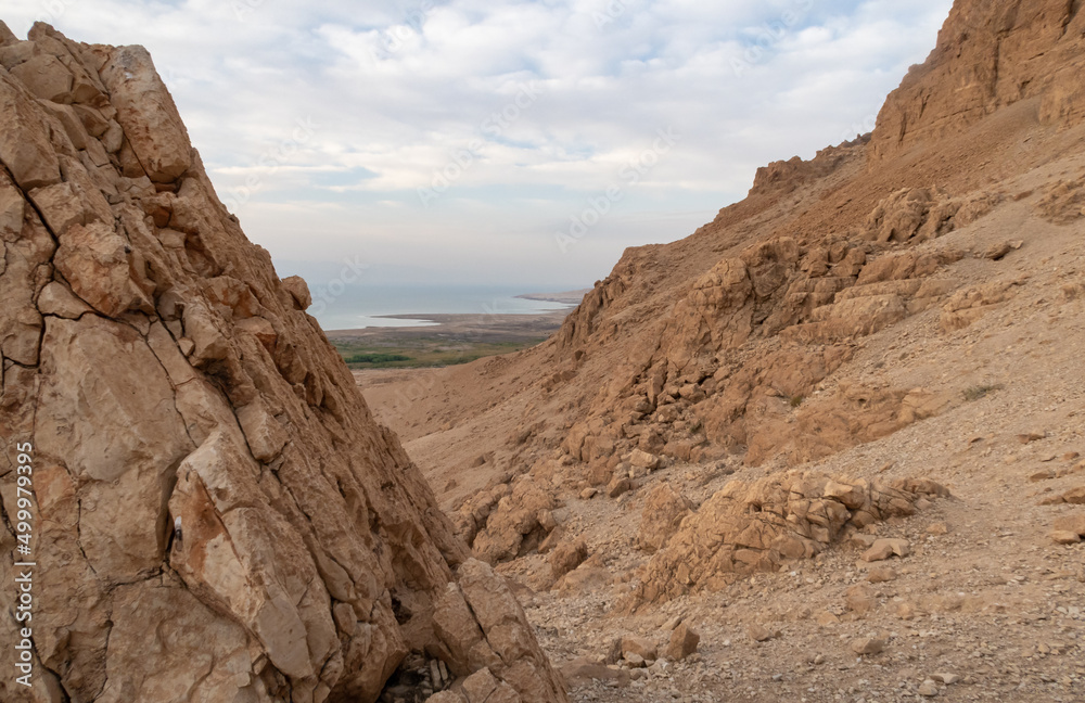 View  from a mountain near the Tamarim stream on the Israeli side of the Dead Sea at sunrise over the Dead Sea and over the mountains on the Jordan side near Jerusalem in Israel
