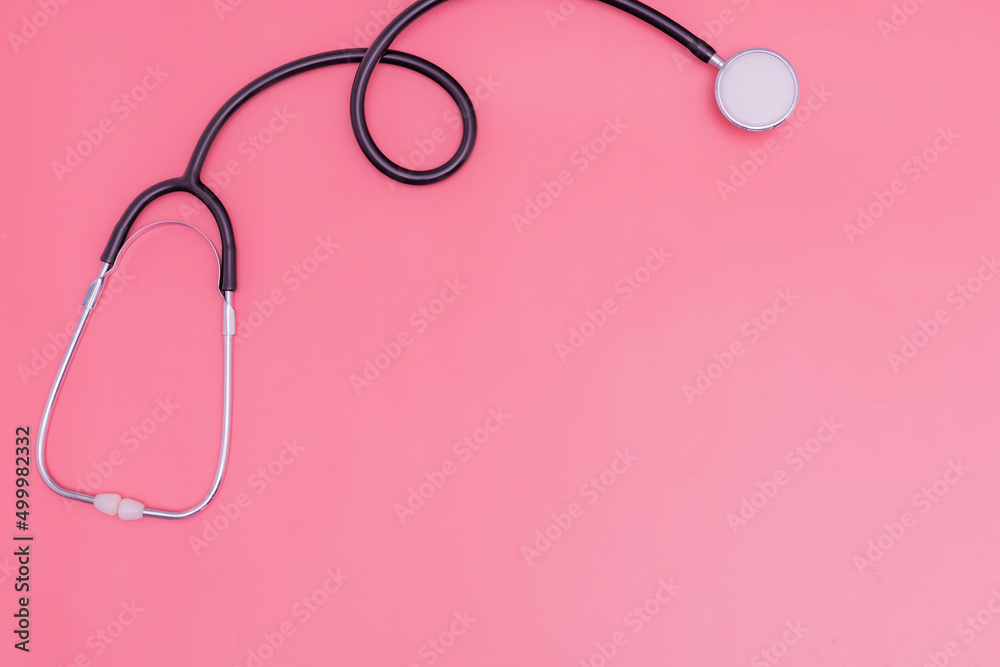 Fototapeta premium stethoscope on pink background and copy space