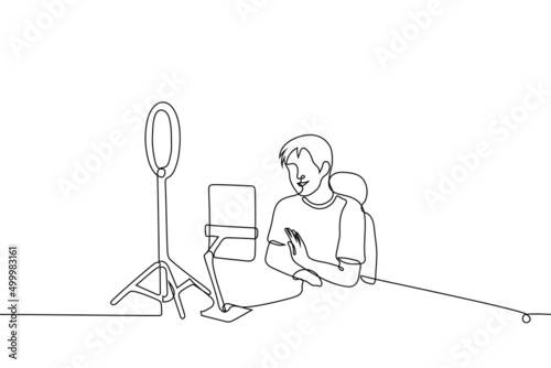 male blogger or celebrity live streaming using tablet and ring lamp - one line drawing vector. concept of live, online streaming on social networks, communication with subscribers or fans