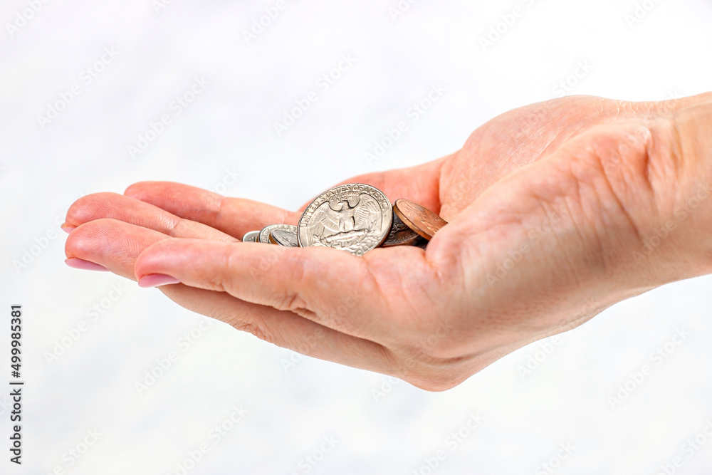 Usa coins in Caucasian woman hands on light background. Money, tips and savings concept. Usa coins in Caucasian woman hands on light background. Money, tips and savings concept.