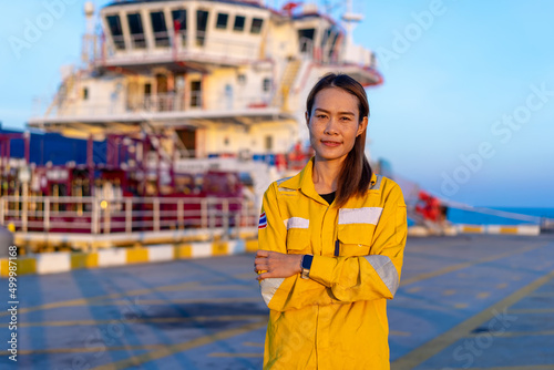 Asian woman is wear a yellow work uniform in an oil Platform or offshore work photo