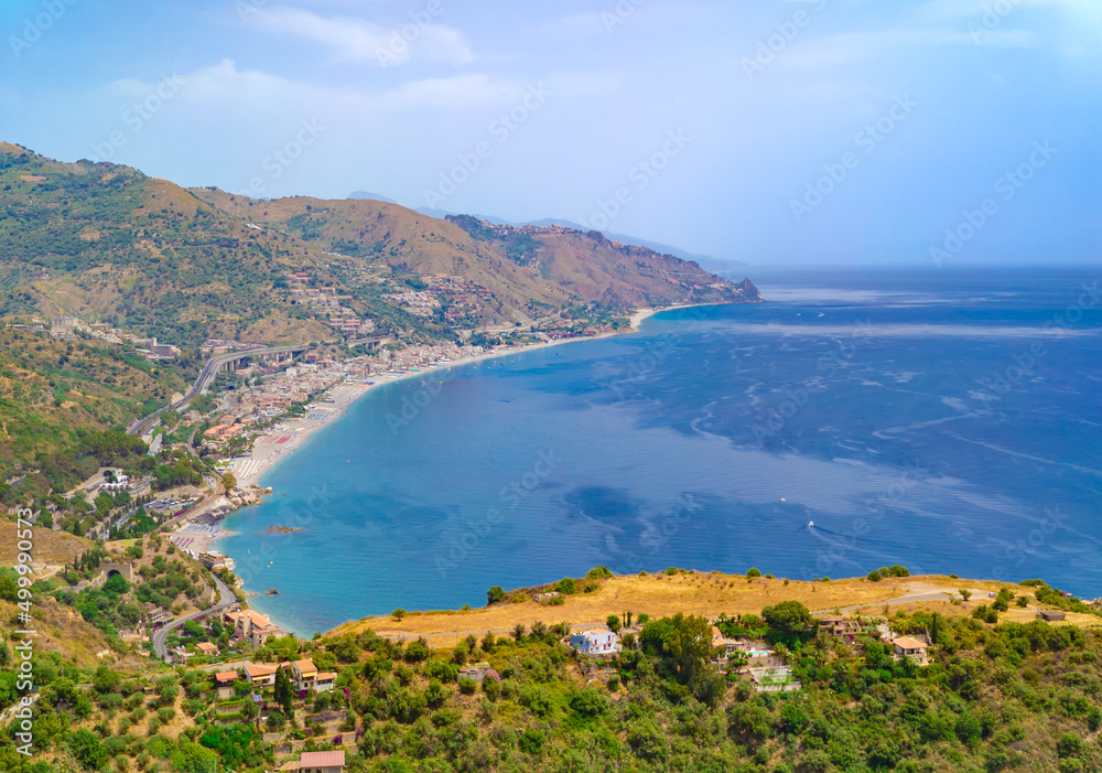 Taormina (Sicilia, Italy) - A historical center view of the touristic city in province of Messina, Sicily island, during the summer, famous for Isola Bella beach and the old theatre