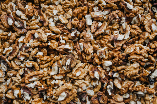 Background, texture of brown walnuts, peeled nuts. Food photography, top view.