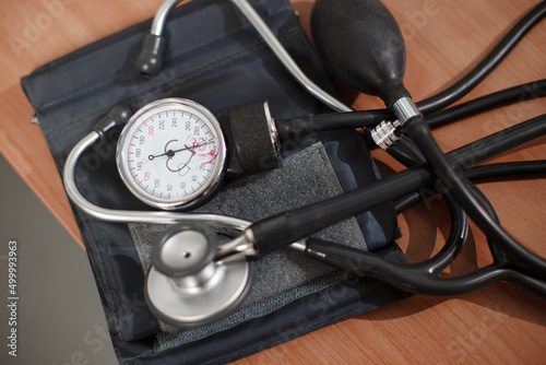 Tonometer with mechanical device for measuring pressure and a doctors hands writing recepy in the background