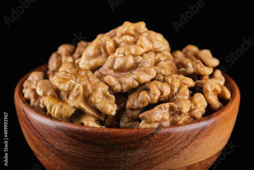Walnuts in wooden bowl. Healthy vegan food concept