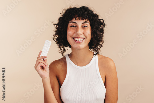 Woman holding a packet of the mini pill photo