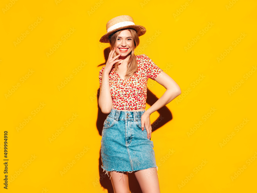 Portrait of young beautiful smiling blond female in trendy summer clothes. carefree woman posing near yellow wall in studio. Positive model having fun indoors. Cheerful and happy. In hat Portrait of young beautiful smiling blond female in trendy summer clothes. carefree woman posing near yellow wall in studio. Positive model having fun indoors. Cheerful and happy. In hat